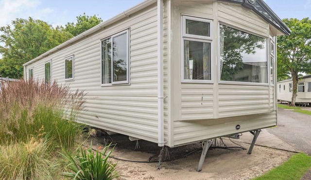 Gold Caravan. With parking and decking.