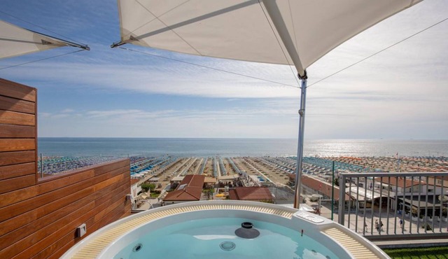 Luxurious and modern penthouse facing the sea with private solarium on the seafront of Lido di Camaiore with private parking space. The flat is on two levels.The flat opens with the bright living room where there is a comfortable doublebed sofa, dining a